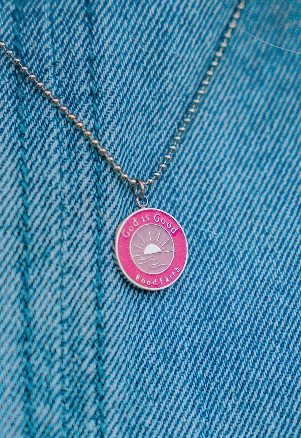 Necklace with a pink pendant on a denim background