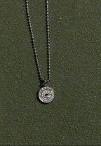 silver necklace that says god is good